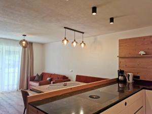 a kitchen and living room with a couch and a table at Haus Bodner in Kartitsch