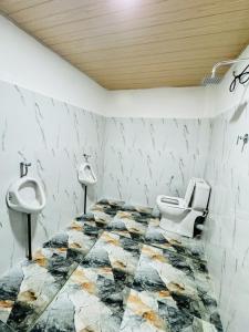 a bathroom with a toilet and a sink at Glowhaven Hostel in Sigiriya