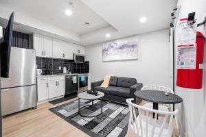 a kitchen and living room with a couch and a table at Suite in Ambleton - Calgary in YYC +35 photos