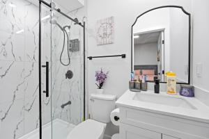 a bathroom with a shower and a toilet and a sink at Suite in Ambleton - Calgary in YYC