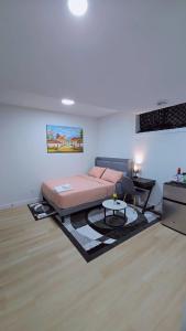 a living room with a bed and a table at Suite in Ambleton - Calgary in YYC