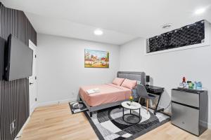 a small room with a bed and a desk at Suite in Ambleton - Calgary in YYC