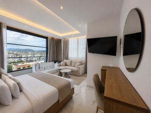 a bedroom with a large bed and a large mirror at Rooftop panoramic jacuzzi room in Ksamil