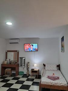 a bedroom with a bed and a tv on the wall at Nikol's house in Kámpos