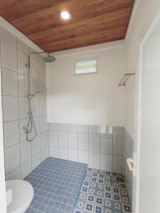 a bathroom with a shower and a toilet and a sink at Toba-A-Scape in Ambarita +122 photos