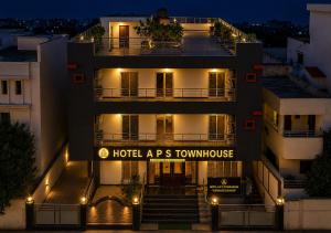 a building with a hotel aps townhouse at night at Hotel A P S Townhouse in Prayagraj