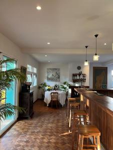 a dining room with a table and chairs in it at Grande Maison Mandrosoa in Abohijanahary