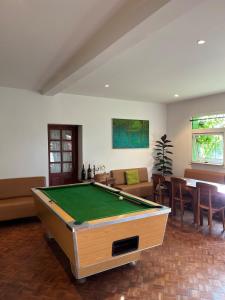a living room with a pool table in it at Grande Maison Mandrosoa in Abohijanahary