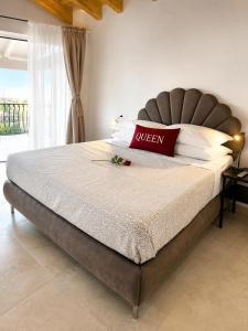 a bed in a bedroom with a red pillow on it at Incanto del Garda in Monzambano