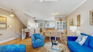 a living room with a blue couch and a table at Rehoboth Crossing - 36983 Grindstone Ln in Rehoboth Beach