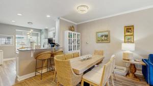 a kitchen and dining room with a table and chairs at Rehoboth Crossing - 36983 Grindstone Ln in Rehoboth Beach