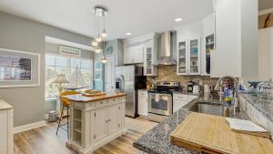 a kitchen with white cabinets and a counter top at Rehoboth Crossing - 36983 Grindstone Ln in Rehoboth Beach