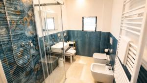 a bathroom with a sink and a toilet and a shower at Incanto del Garda in Monzambano