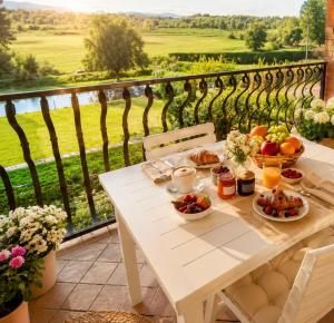 a white table with fruits and vegetables on a balcony at Incanto del Garda in Monzambano