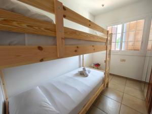 a bedroom with two bunk beds with white sheets at Bonamar in Cabrera de Mar +23 photos