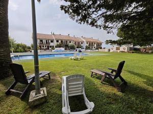 two chairs and a picnic table next to a pool at Bonamar in Cabrera de Mar