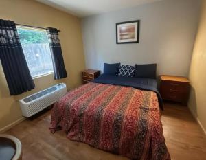 a bedroom with a bed and a window at Crown Inn in Carrollton