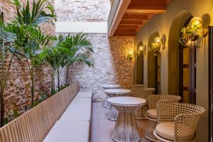a row of tables and chairs on a patio at Hotel El Balconario by Faranda Boutique in Cartagena de Indias