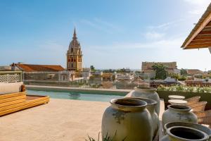 a group of vases sitting on top of a roof at Hotel El Balconario by Faranda Boutique in Cartagena de Indias