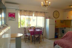 a kitchen with a table and a white refrigerator at Beaches within walking distance private parking! in Six-Fours-les-Plages