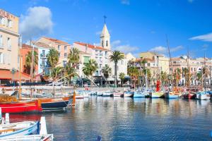 a group of boats docked in a harbor with buildings at Beaches within walking distance private parking! in Six-Fours-les-Plages