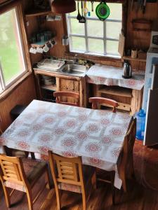 a kitchen with a table and chairs and a sink at Birloche in Pindapulli +16 photos