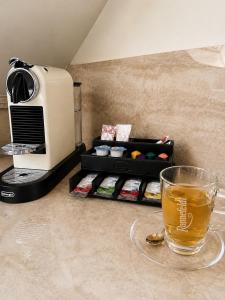 a cup of tea sitting on a counter next to a toaster at Büdel's Spessart Lounge in Lohr am Main +4 photos
