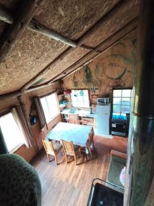 a dining room and kitchen in a log cabin at Birloche in Pindapulli