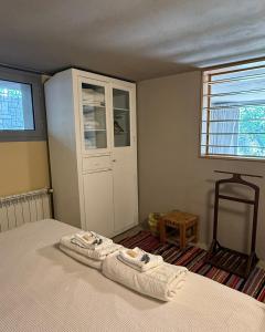 a bedroom with a bed with two towels on it at Dar el Maasser in Maasser El Chouf