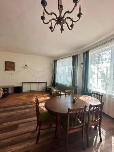 a dining room with a table and chairs and a chandelier at Ocypello in Ocypel