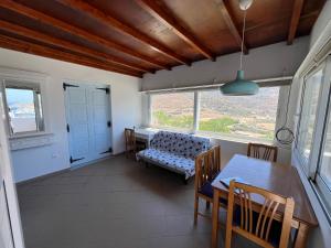 a dining room with a table and a bench at Ageon Amorgos in Amorgos