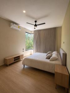 a bedroom with a large bed and a window at Villa horizonte in Playa del Carmen +12 photos