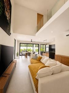 a living room with a couch and a tv at Villa horizonte in Playa del Carmen