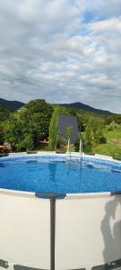 a large blue swimming pool with a view of a mountain at Colorful Space in Kotoraantkari