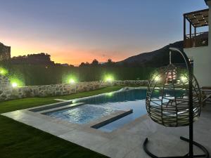 a swimming pool with a swing in a yard at Villa Keyf Göcek in Fethiye