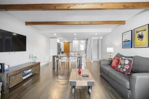 a living room with a couch and a table at Luxury Condominium with Rustic Minimalist Style in Mont-Tremblant
