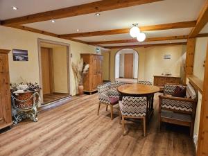 a dining room with a wooden table and chairs at Gasthof - Restaurant Löcker in Radstadt +26 photos