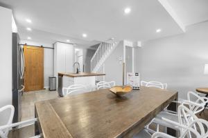 a kitchen and dining room with a wooden table and chairs at Luxury Condominium with Rustic Minimalist Style in Mont-Tremblant