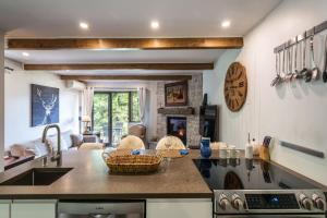 a kitchen with a counter with a sink and a stove at Simple & Luxe Condo With View in Mont-Tremblant +12 photos