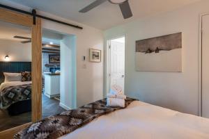 a bedroom with a large bed with a large window at Simple & Luxe Condo With View in Mont-Tremblant