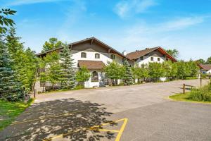 a house with a driveway with a house at Simple & Luxe Condo With View in Mont-Tremblant