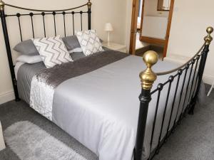 a bedroom with a large bed with a black frame at lake District cottage in Bootle
