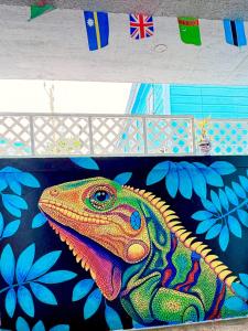 a colorful painting of a lizard on a table at Drift Inn San Pedro in San Pedro