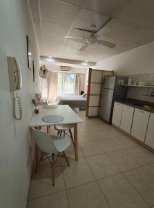 a kitchen with a table and chairs in a room at Apart Zeta in Belén de Escobar +9 photos