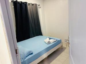 a small bed in a room with a black shower curtain at Hiyaa H7 in Hulhumale