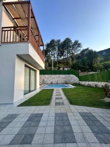 a house with a stone wall and a patio at Villa Keyf Göcek in Fethiye