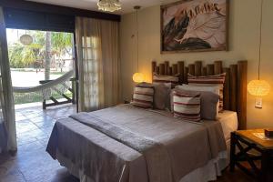 a bedroom with a large bed and a large window at Hotel Rede Beach in Trairi +110 photos