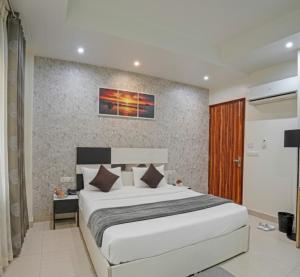 a bedroom with a large bed in a room at Hotel Church House - Rohini I Near Metro I Spacious Rooms I Friendly Staff I Most Preferred Hotel In Rohini in Delhi +37 photos