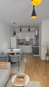 a living room with a table and a kitchen at Lovely apartmant Bar in Bar