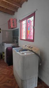 an old tub in a room with a window at Sendero Ancestral in Guarne